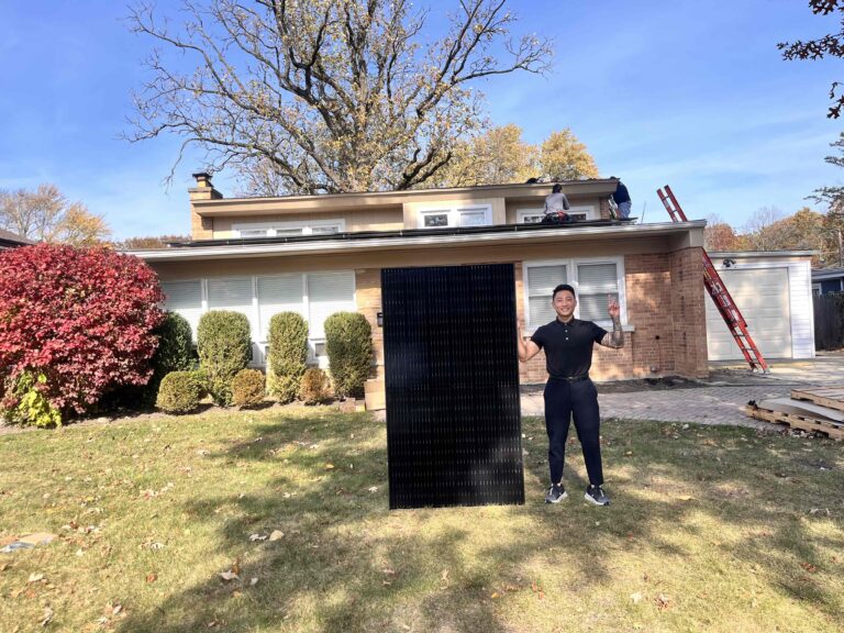 solar rep holding solar panel in front of residential home during installation day