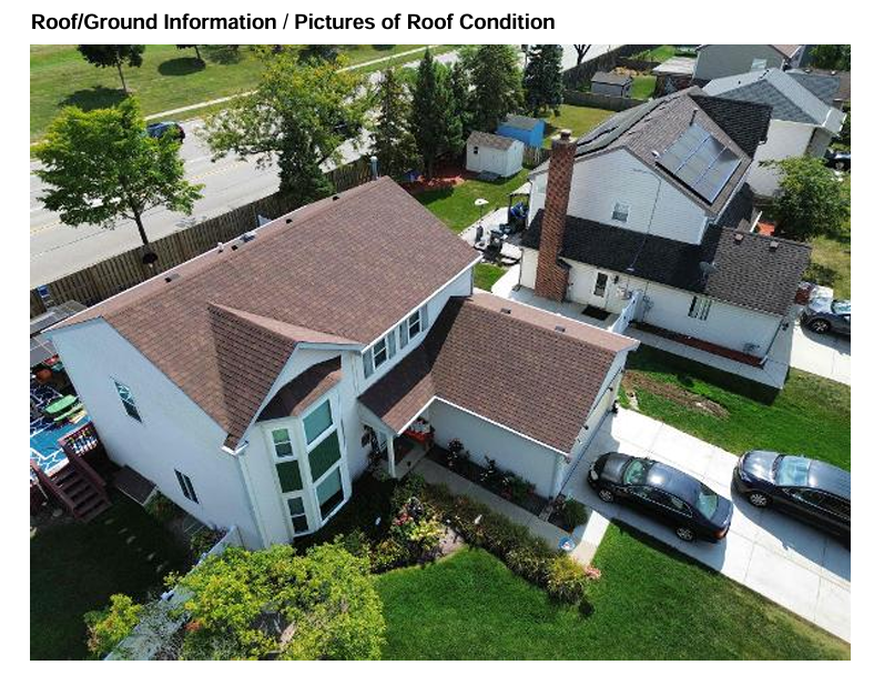 Aerial view of residential rooftop showing clean roof condition