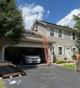 MSI crew installing PV system on residential home in Illinois with ladders and equipment visible
