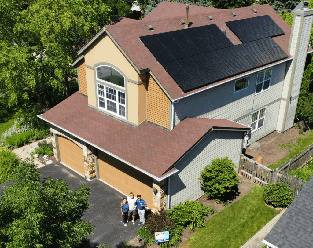 drone shot of completed residential solar install with MSI sales rep and homeowners in picture
