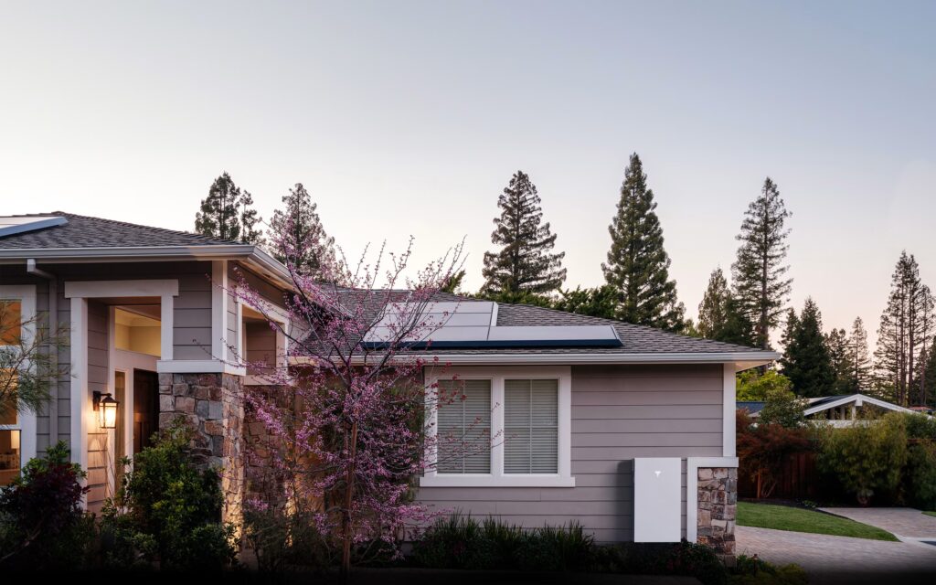 Tesla Powerwall battery installed on a residential wall, part of an integrated solar energy system.