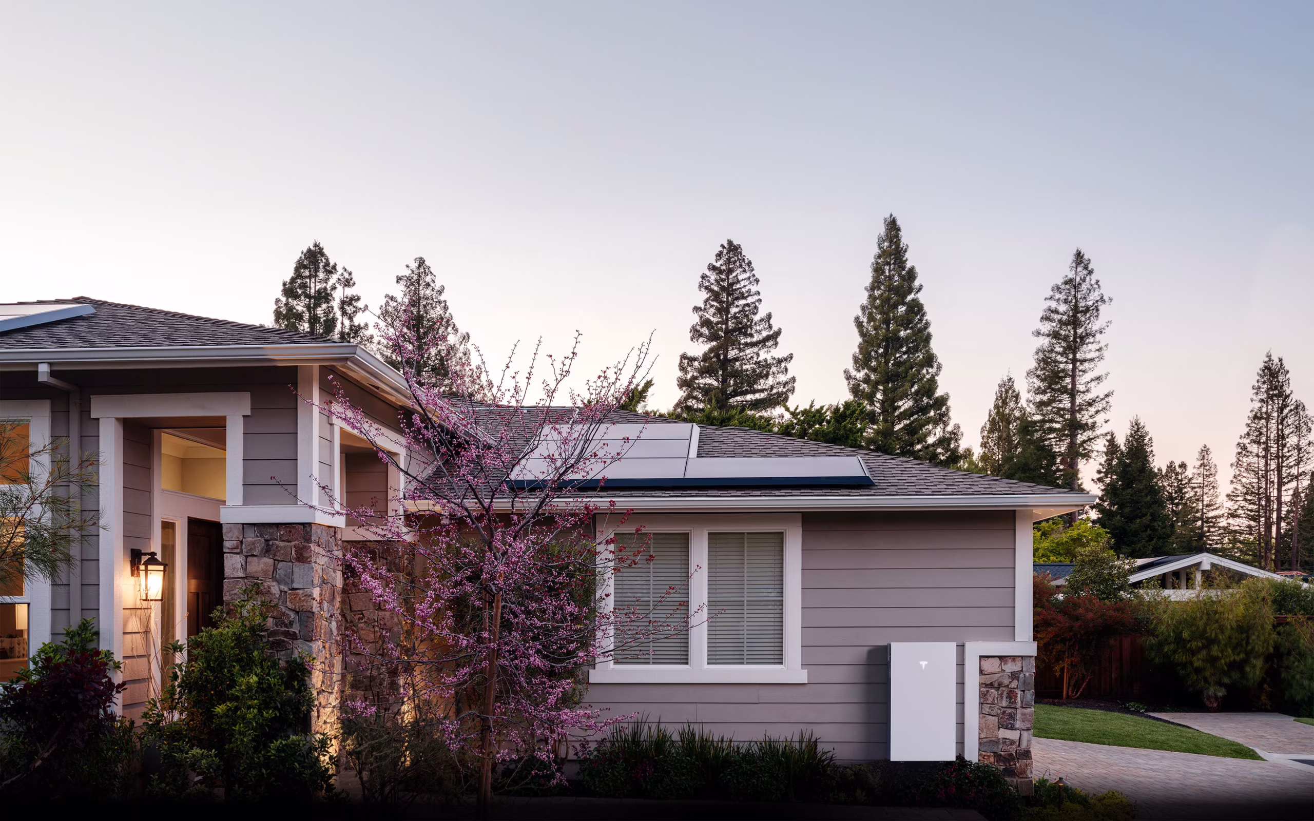 Tesla Powerwall battery installed on a residential wall, part of an integrated solar energy system.